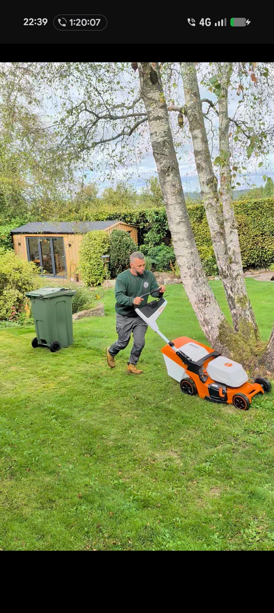 Mitch mowing a lawn in a domestic garden